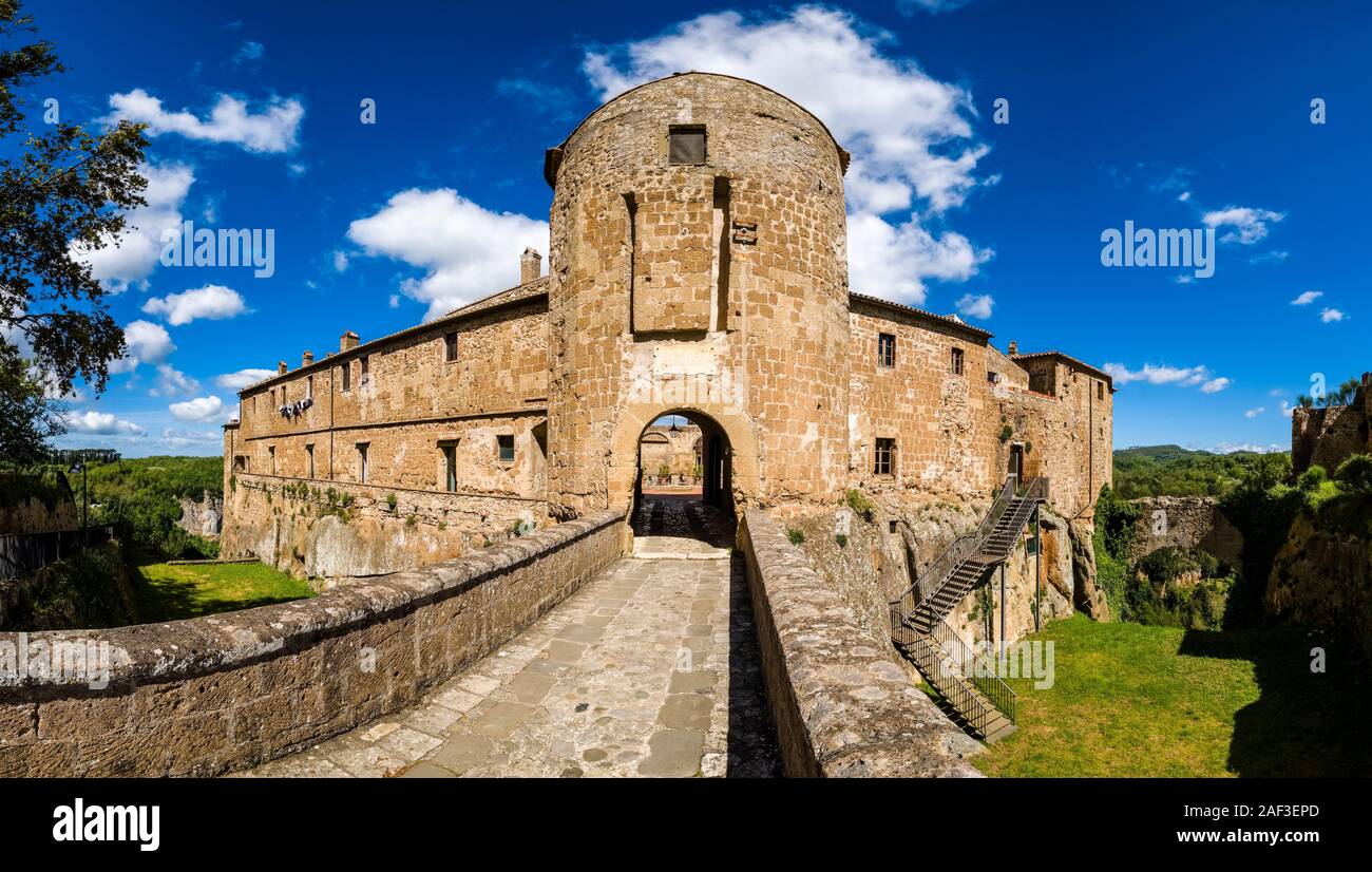 Panoramic view of the entrance gate and walls of the Fortezza Orsini, wooded landscape in the distance Stock Photo