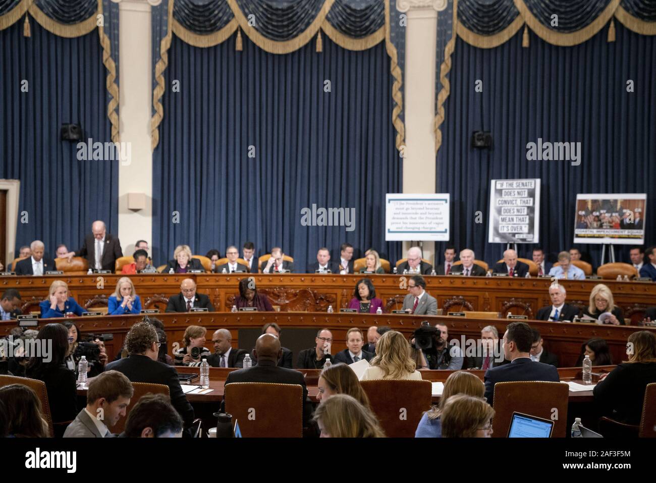 Washington, United States. 12th Dec, 2019. A clerk, bottom center, reads H. Res. 755, Impeaching Donald John Trump, President of the United States for high crimes and misdemeanors, during a House Judiciary Committee hearing in Washington, DC, on Thursday, December 12, 2019. The Judiciary Committee is set to finish debating articles of impeachment against President Donald Trump today with a likely party-line vote to send the resolution to the floor of the House. Photo by Andrew Harrer/UPI Credit: UPI/Alamy Live News Stock Photo