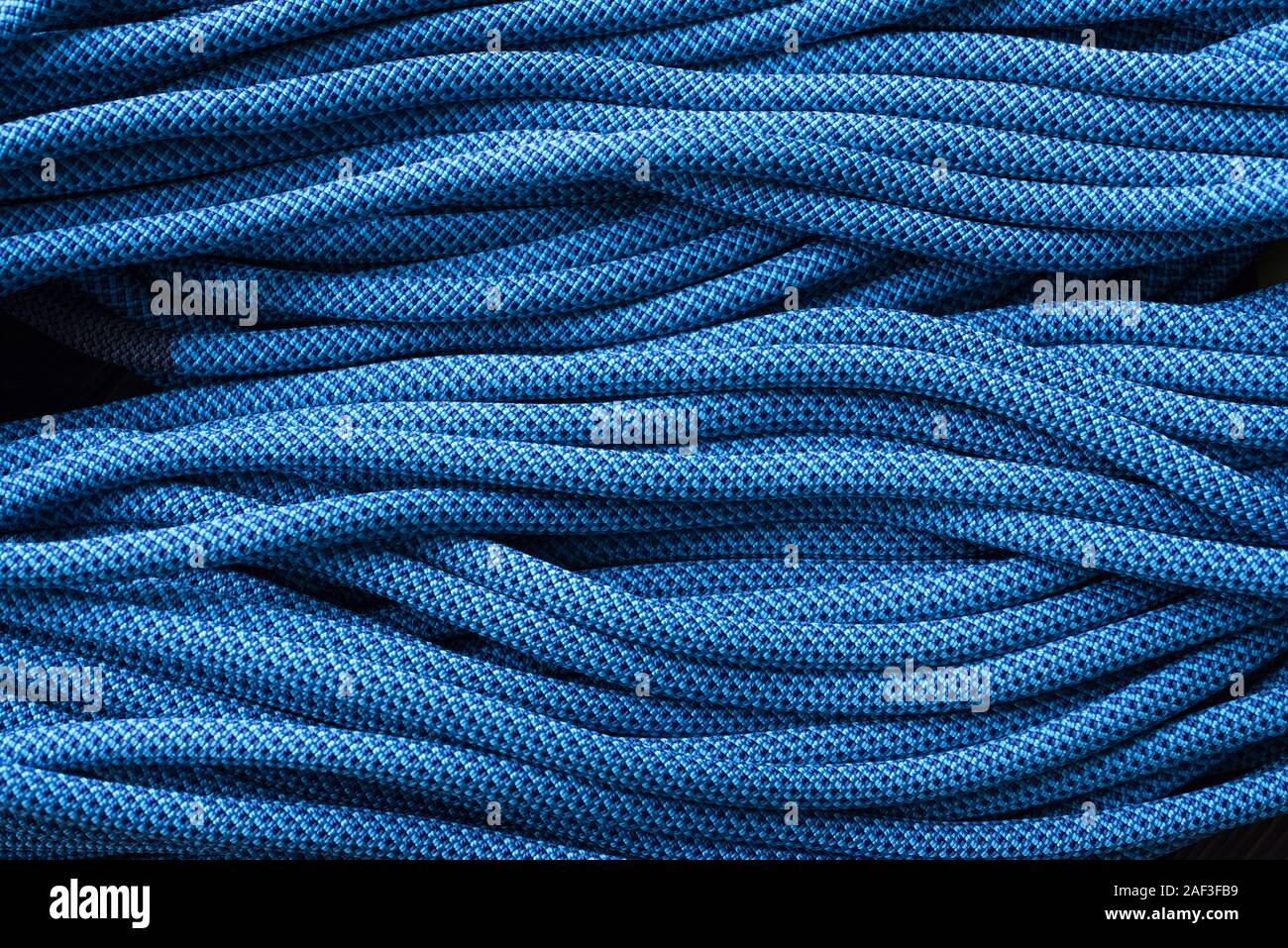 Blue rope for belay. Isolated photo of climbing knots. Top view of ...
