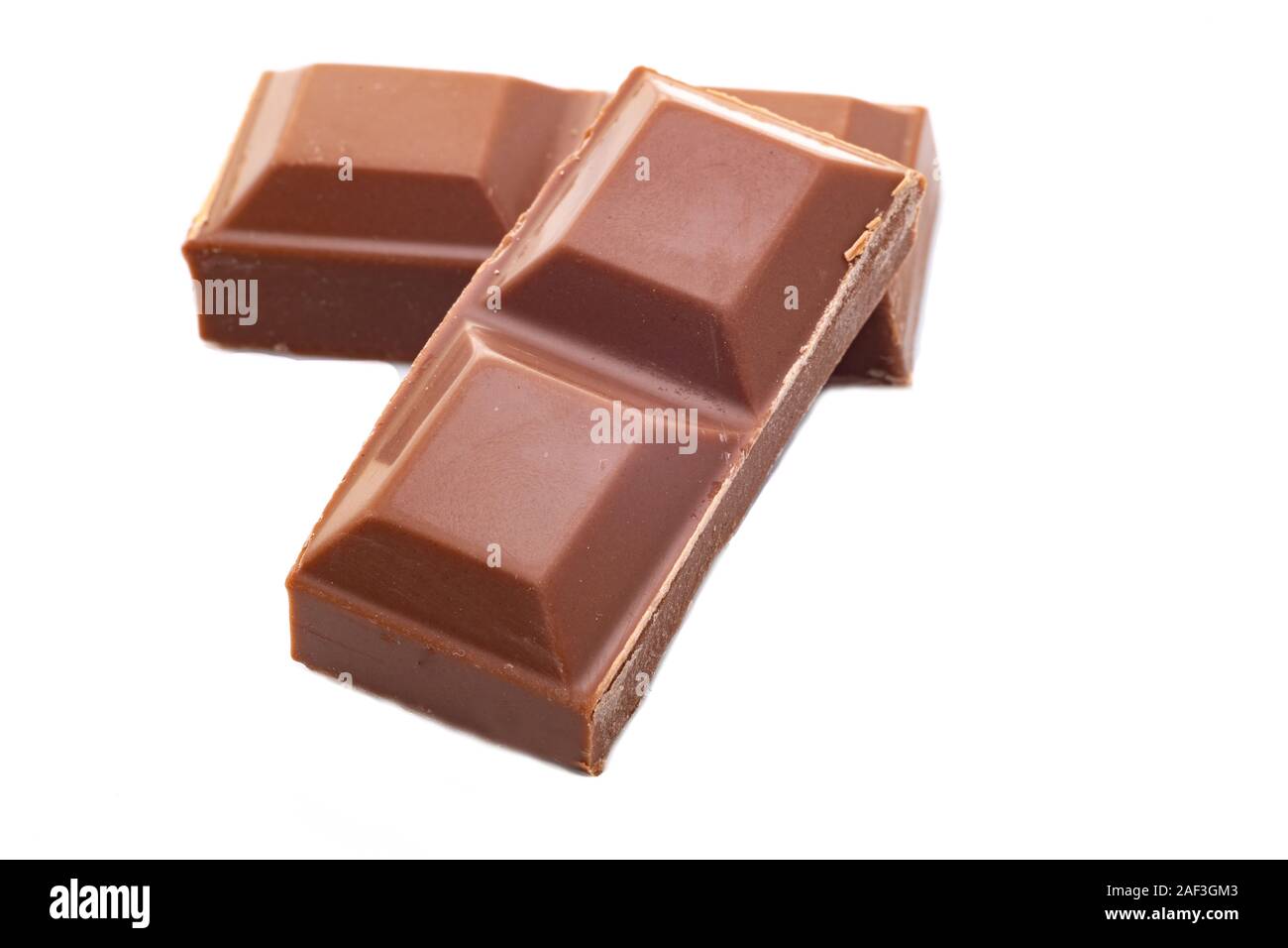 Pieces of milk chocolate - white background Stock Photo