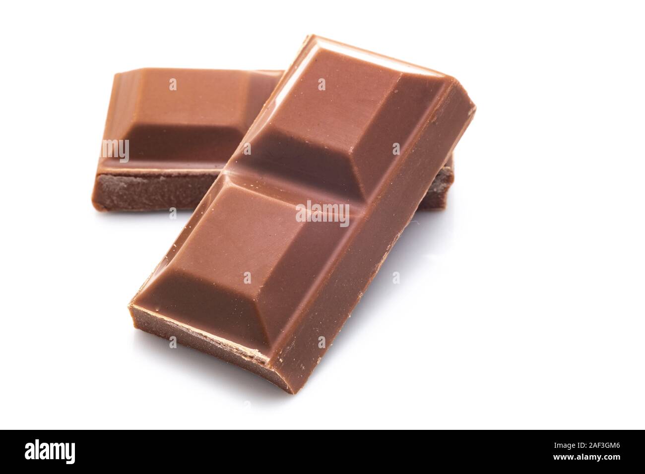 Pieces of milk chocolate - white background Stock Photo