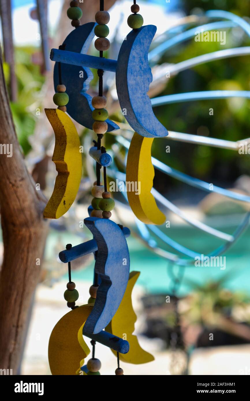 Homemade wind chimes hanging from driftwood. Stock Photo