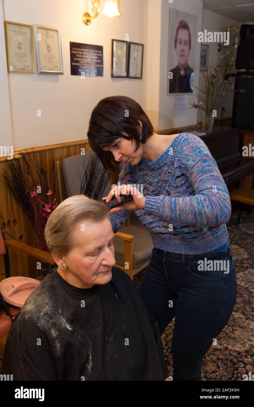 Hairdresser Iwona Piasecka regularly comes to the Bradford Polish community centre to work with elderly ladies of Polish origin. Stock Photo