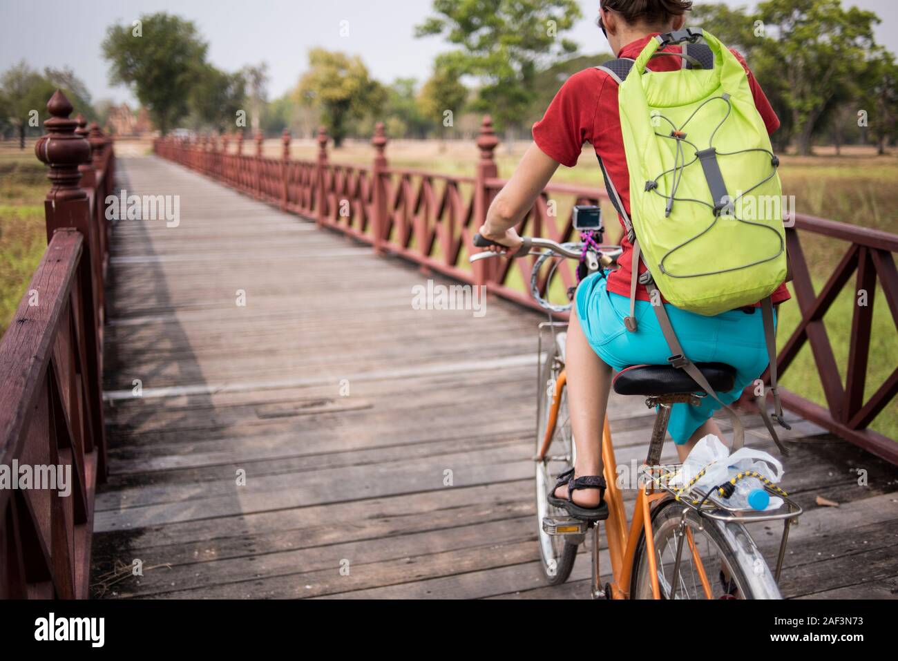 A young female cycling at the Sukhothai Historical site, Sukhothai, Thailand. Stock Photo