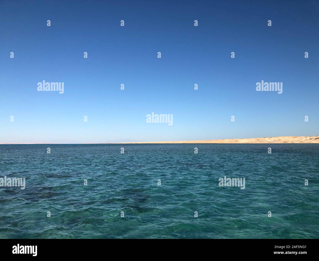 Landscape of tropical ocean with Tiran island on turquoise ocean waves, blue sky. Picture of vacation and travel to Egypt. A good banner for a tourist Stock Photo