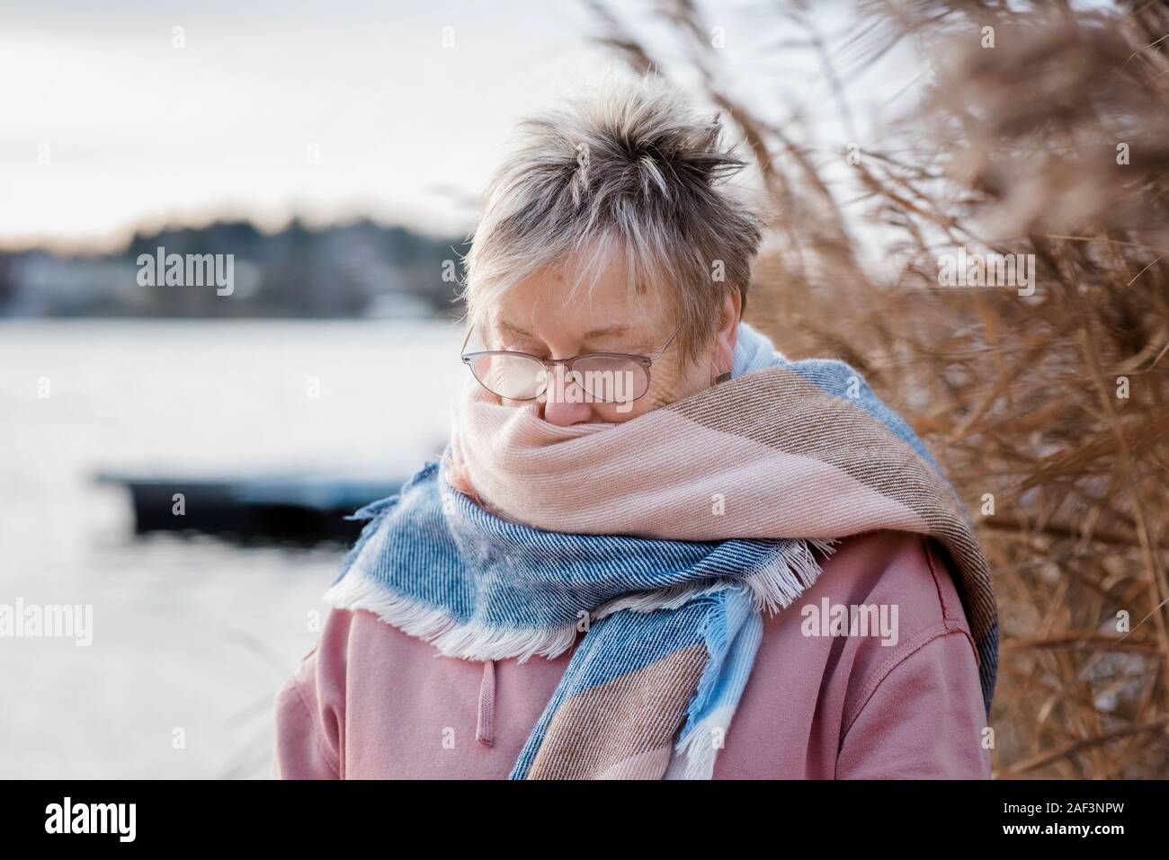 Portrait of a woman in her 60's with her glasses steamed in winter Stock Photo