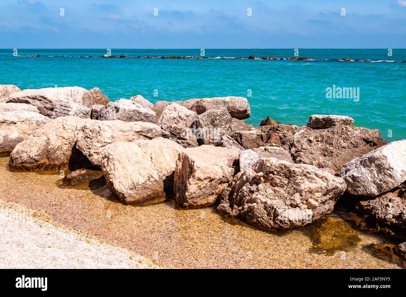Oceanfront Rocks Massive stones rocks lying on the beach as a border between pebble ...