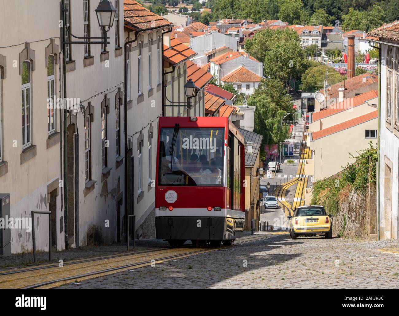 Viseu, Portugal - 19 August 2019: Red tramcar or funicular railway crosses into the old town station Stock Photo