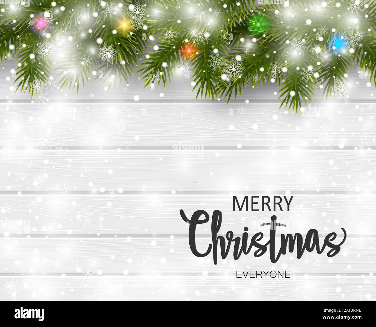 Christmas greeting card with pine branches and snow on white wooden ...