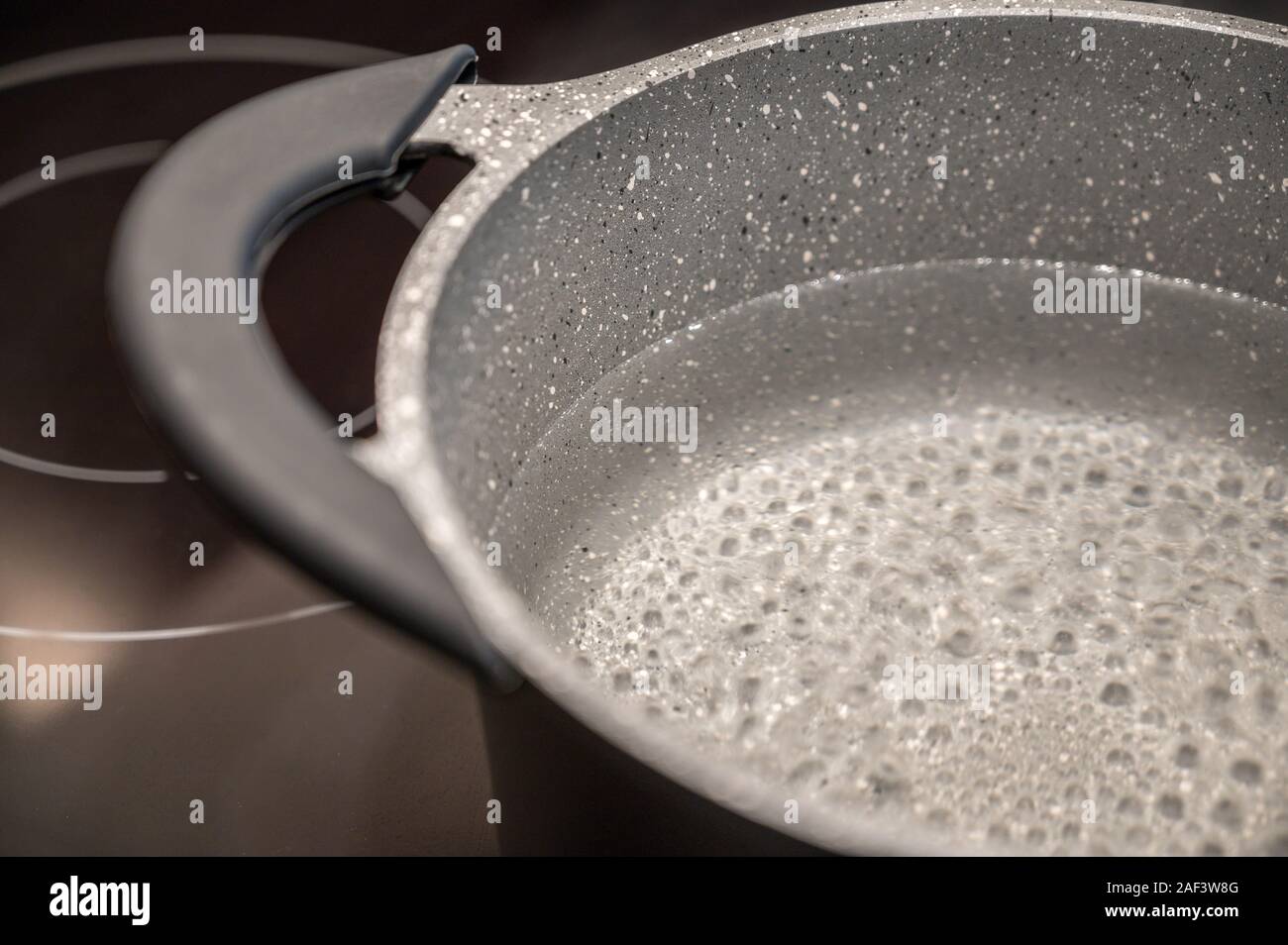 Boiling Water In A Saucepan On An Induction Cooker Stock Photo