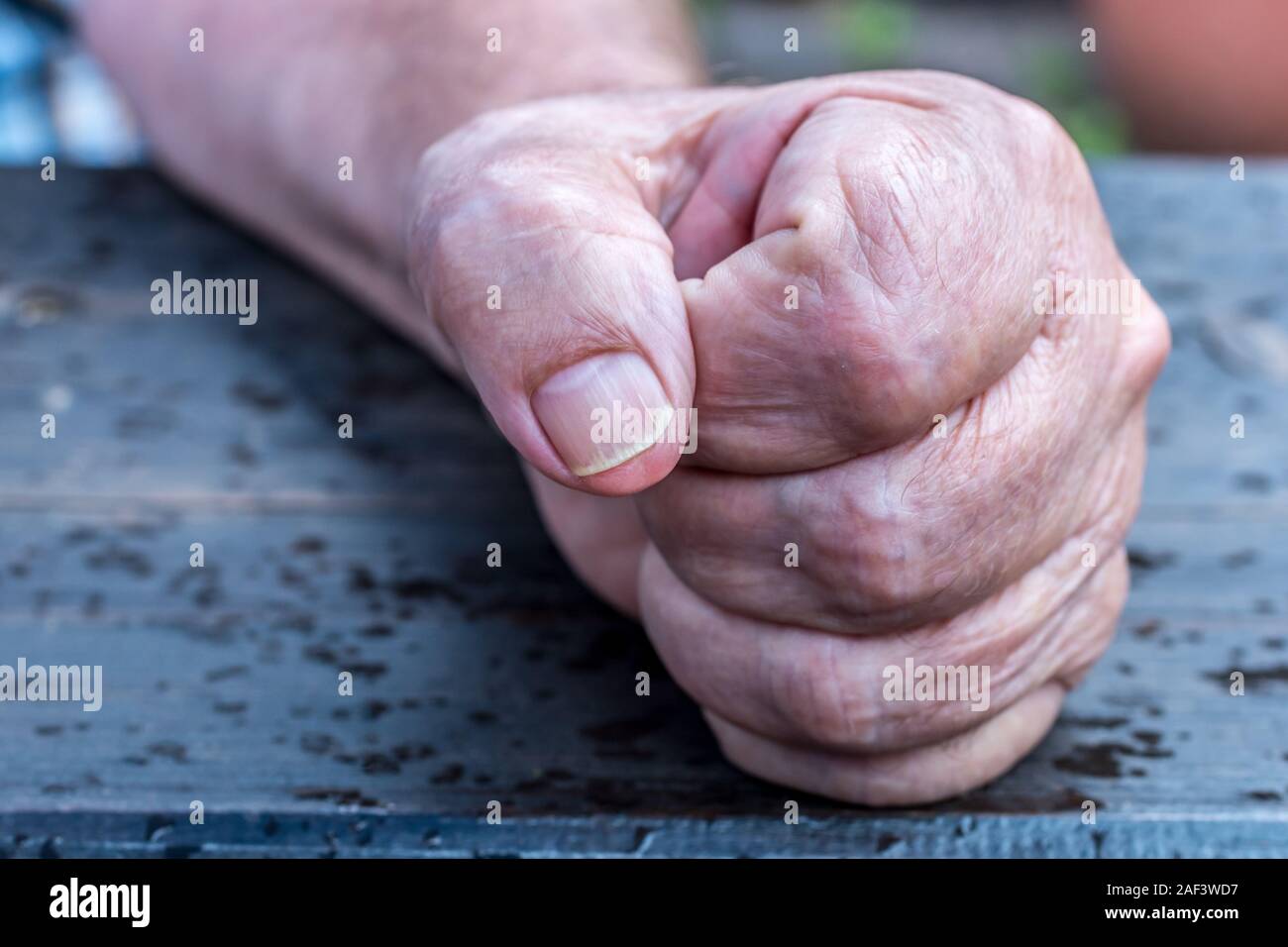 Hand of a man clenched to the fist Stock Photo