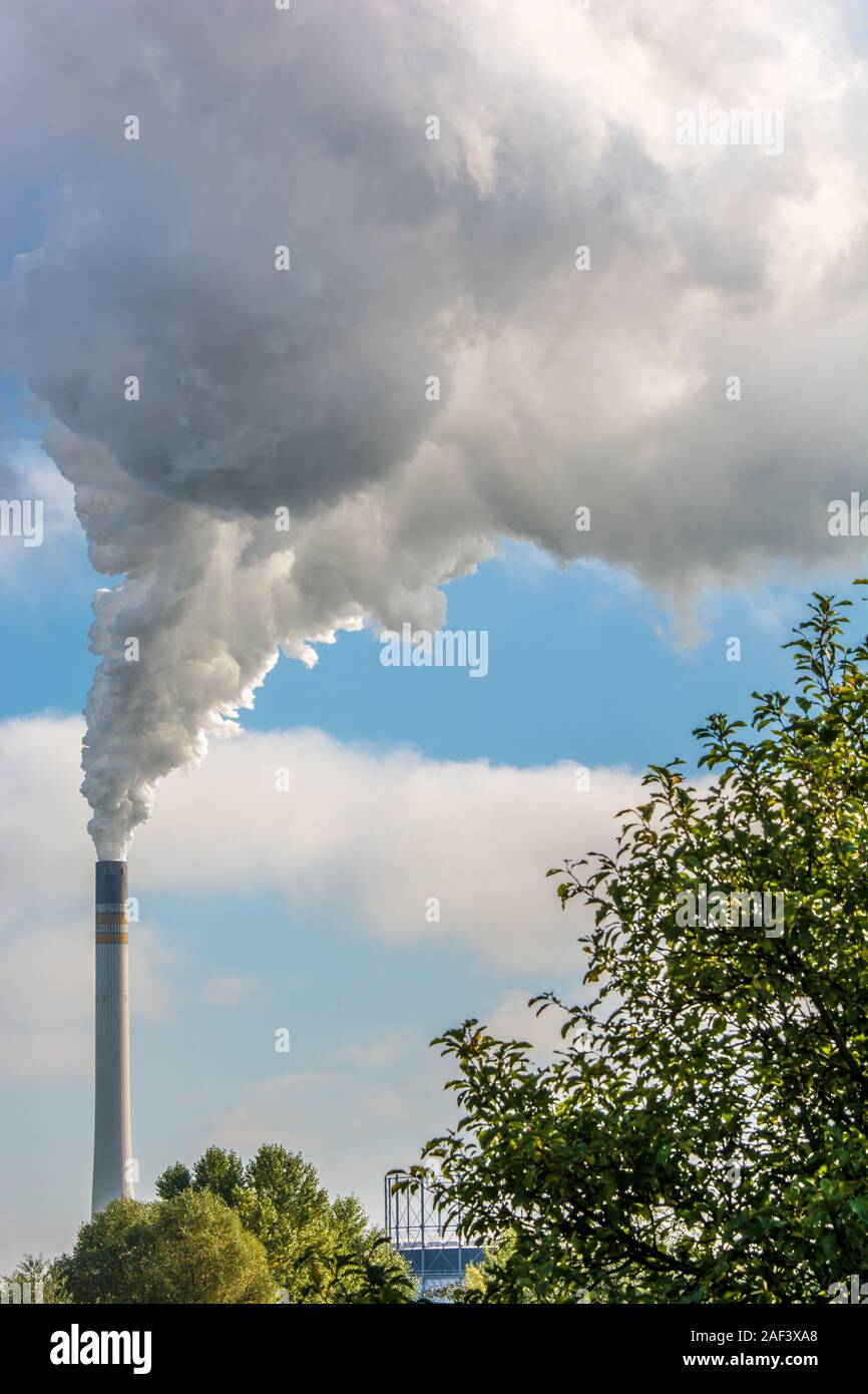 Air pollution from industrial waste gases from a high chimney Stock Photo
