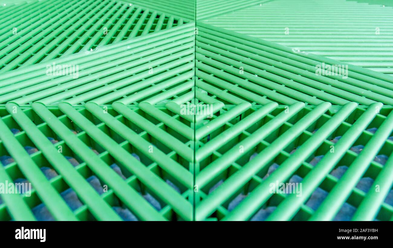 Green plastic rods as a permeable walkway plate for growth of the lawn Stock Photo
