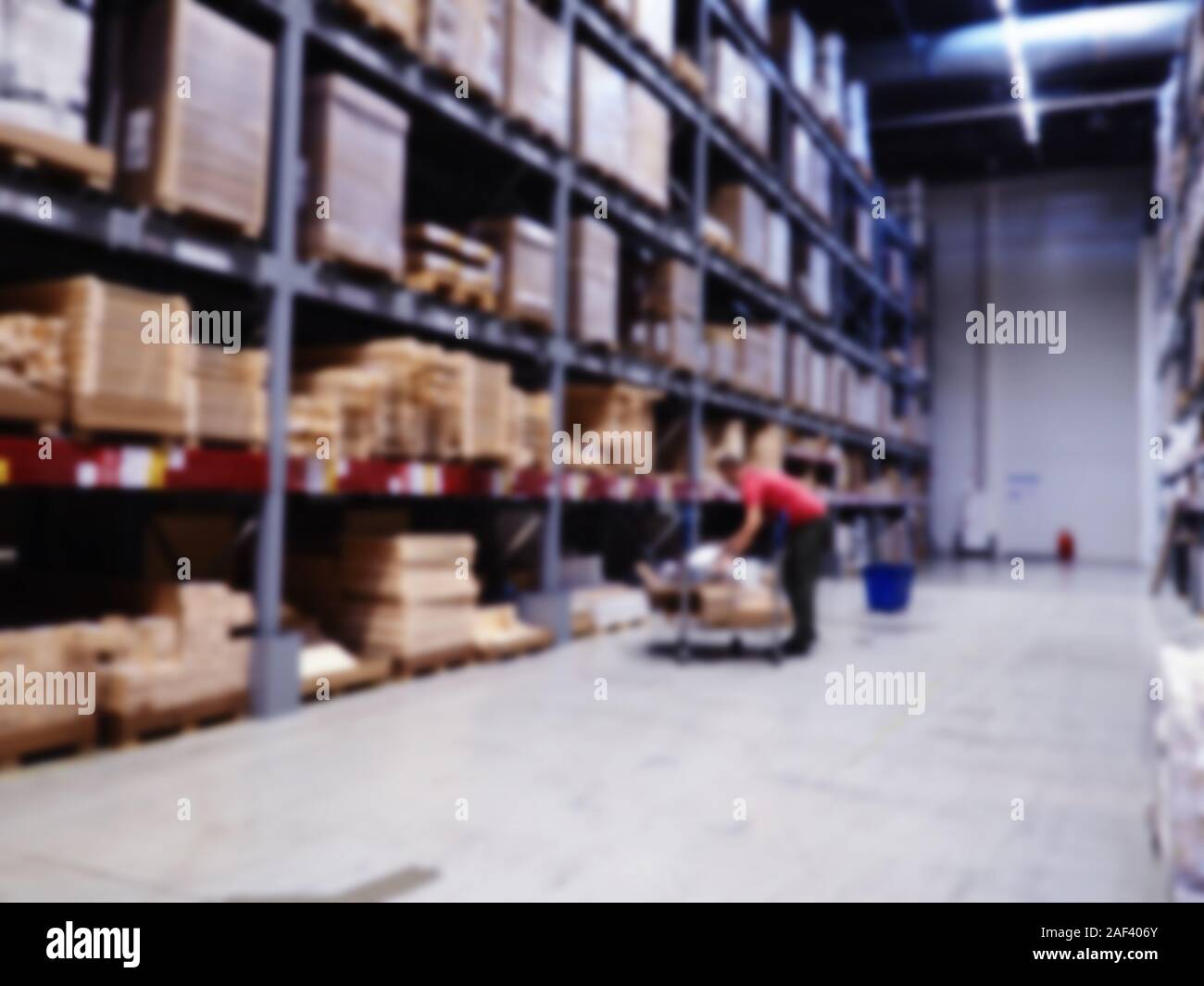 Shelf Storage in hypermarket interior blur background. warehouse with shelves blurred with illumination, logistics, background Stock Photo