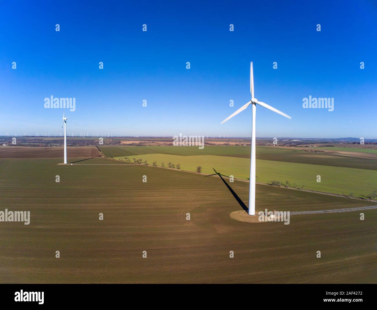 Aerial view of two wind turbines on a field Stock Photo