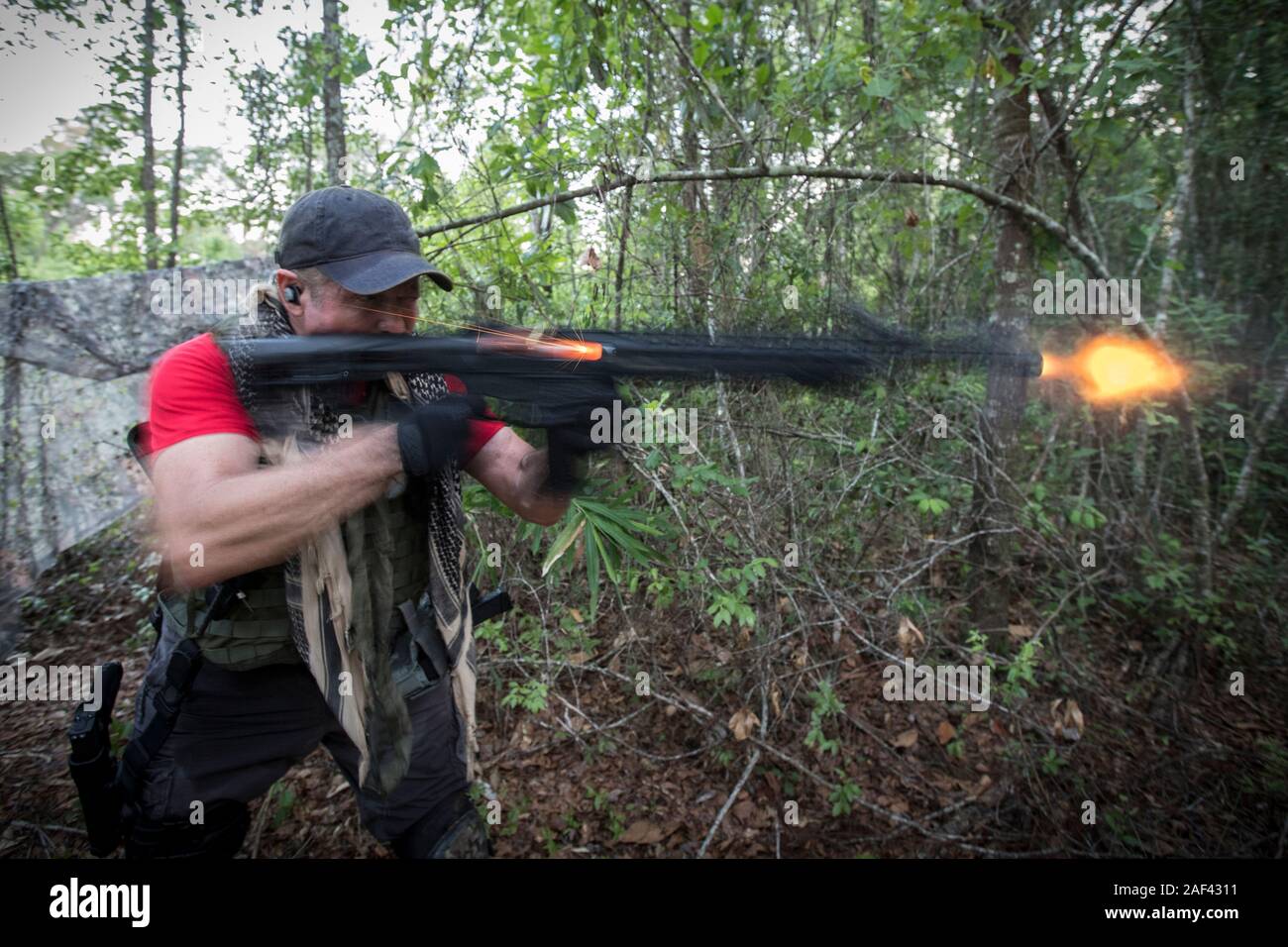 Dressed in military gear a shooting trains on a gun range in southeast