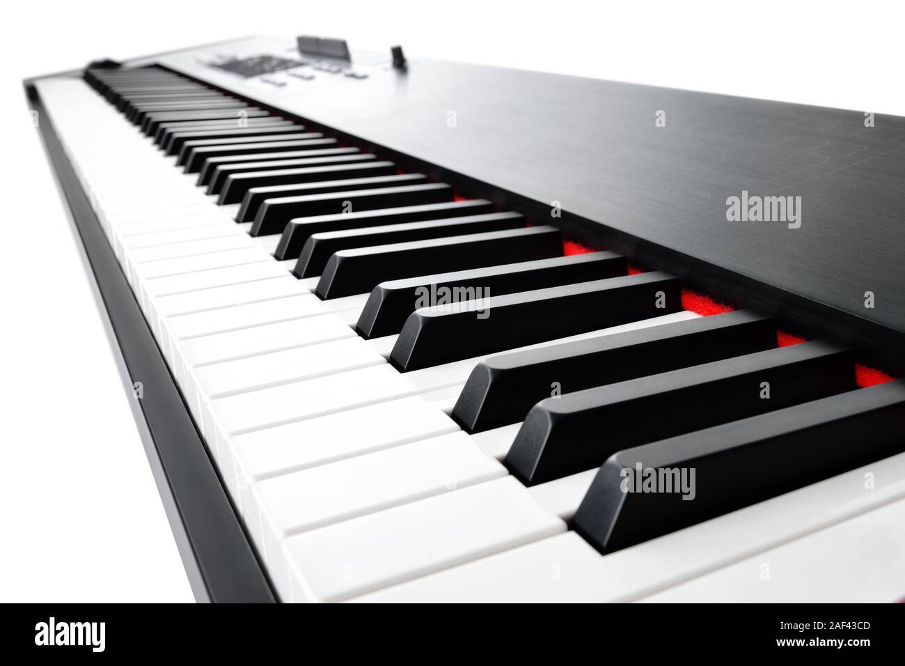Synthesizer keyboard music instrument, studio shot at interesting perspective on white background Stock Photo