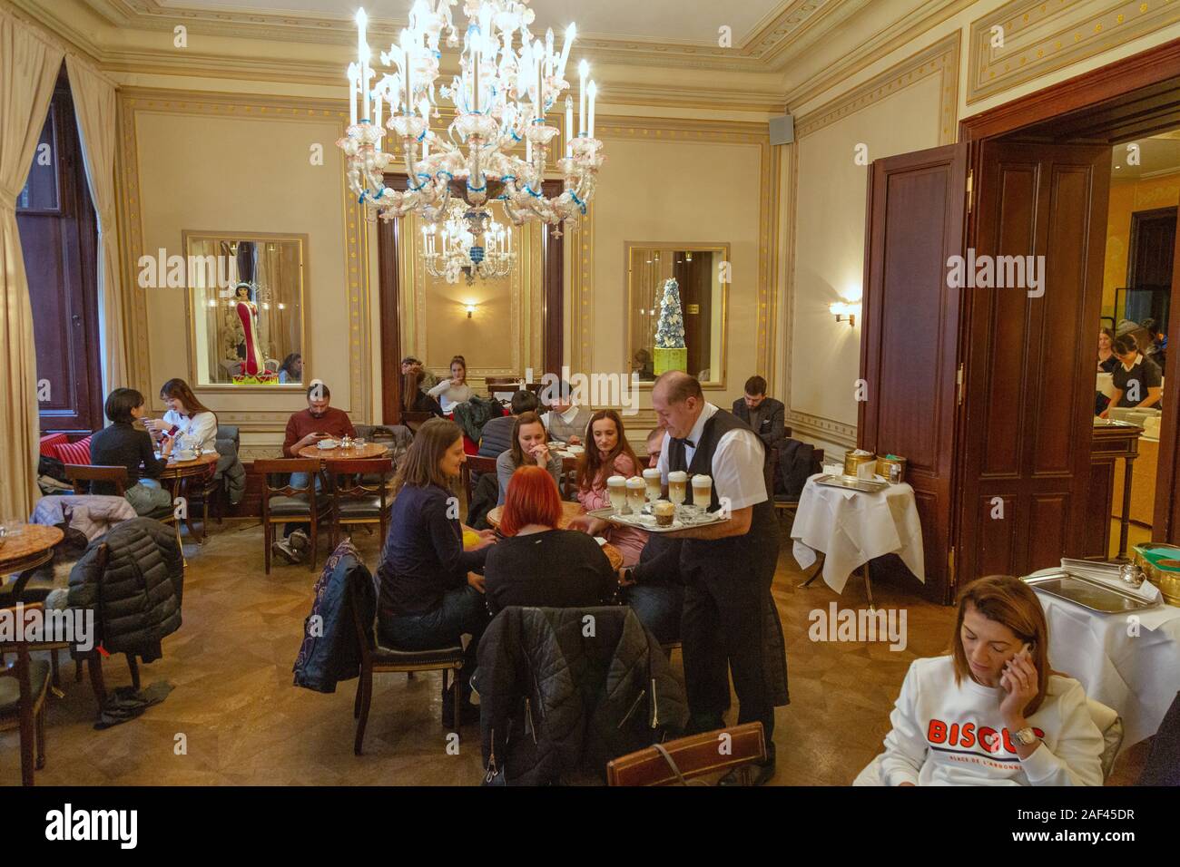 Vienna cafe; a waiter serving customers, The Demel coffee house interior, Vienna Austria Europe Stock Photo