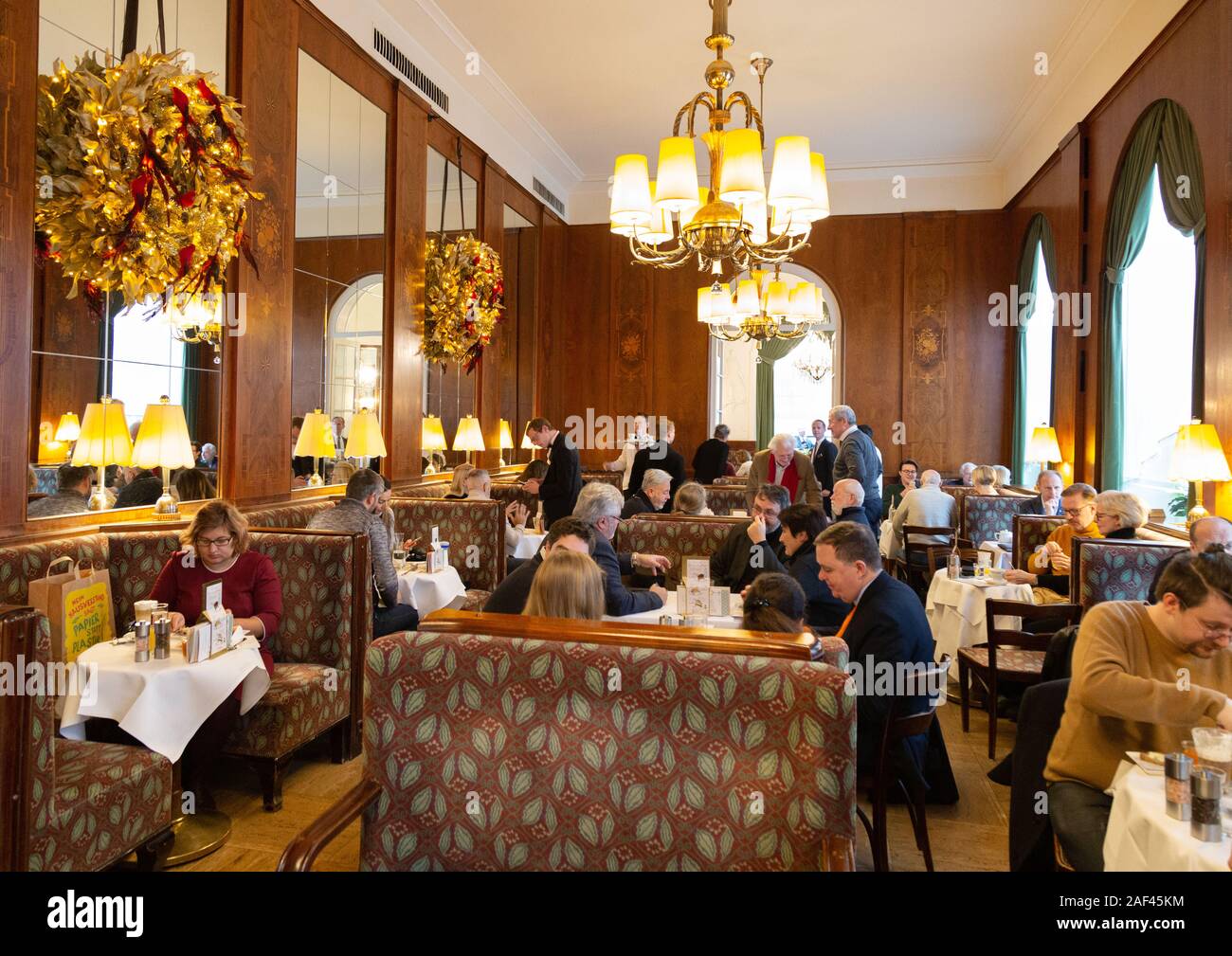 Vienna restaurant and coffee house; people eating and drinking inside the Cafe Landtmann, well known salon and patisserie, Vienna Austria Europe Stock Photo