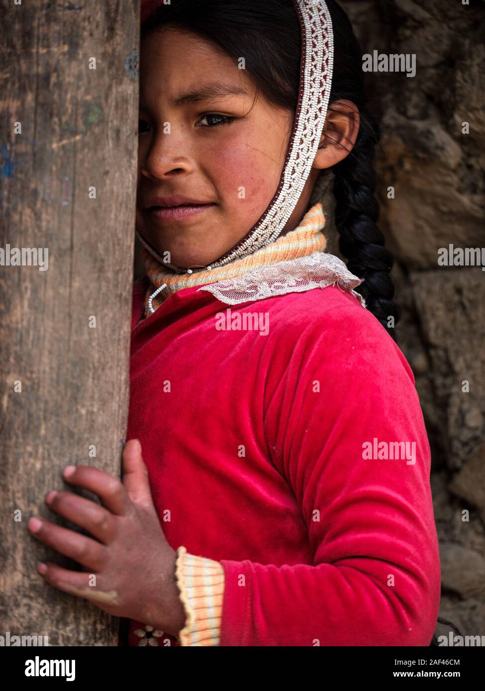 OLLANTAYTAMBO, PERU - CIRCA SEPTEMBER 2019:  Portrait of kid from the andean community of Willoq close to Ollantaytambo in the Sacred Valley of Peru. Stock Photo