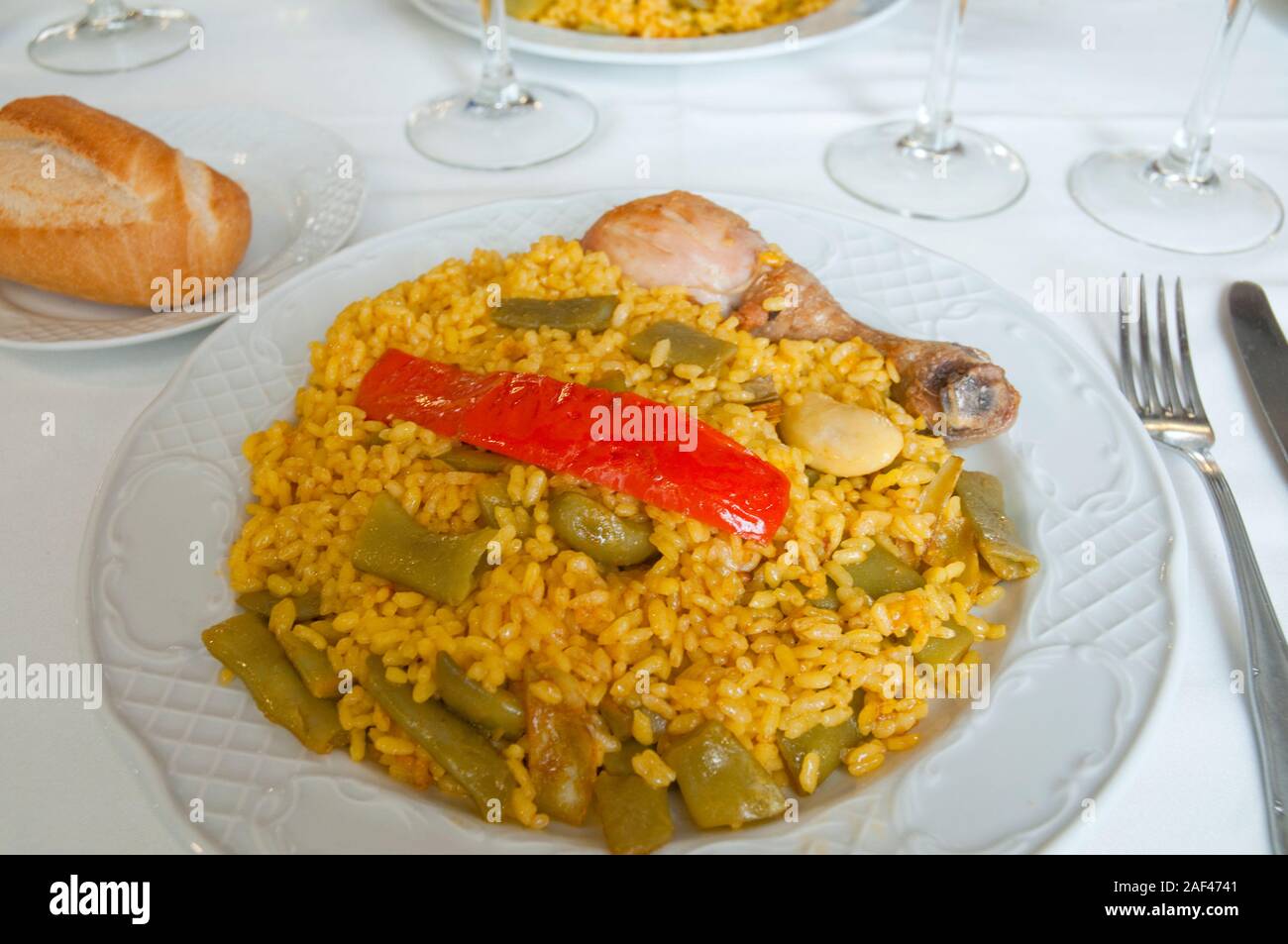 Paella valenciana serving. Spain. Stock Photo