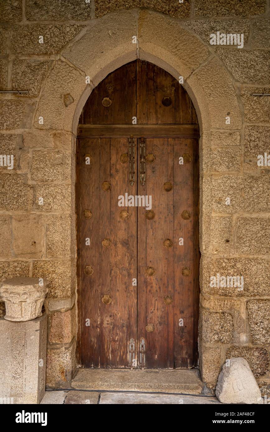 Solid wood and reinforced arched door inside historic monastery in Guimaraes Stock Photo