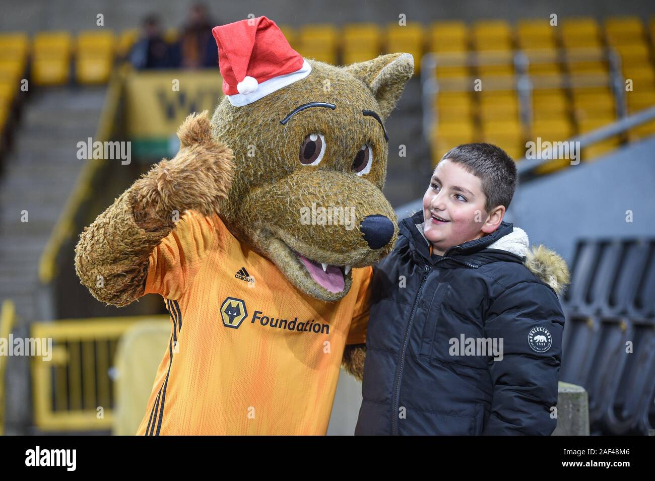 Wolverhampton, UK. 12th Dec, 2019. 12th December 2019, Molineux, Wolverhampton, England; UEFA Europa League, Wolverhampton Wanderers v Besiktas : A young fan with the Wolves mascot Credit: Richard Long/News Images Credit: News Images /Alamy Live News Stock Photo