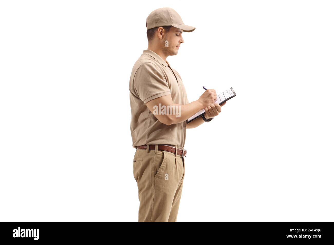 Delivery guy writing in a clipboard isolated on white background Stock Photo
