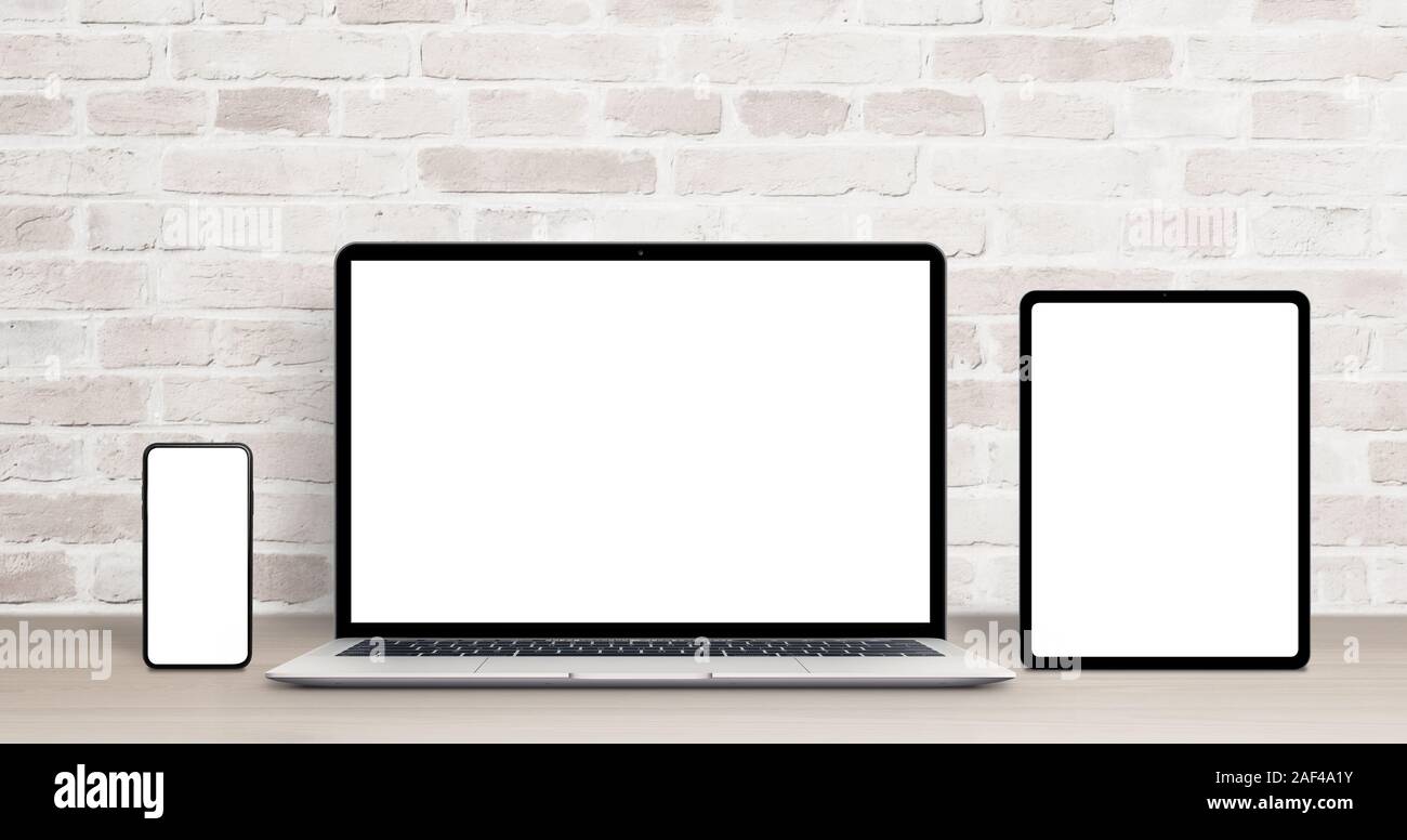 Laptop, tablet and phone mockup on work desk. Modern devices with thin,  round edges. Isolated screens for app or web site presentation. Brick wall  in Stock Photo - Alamy