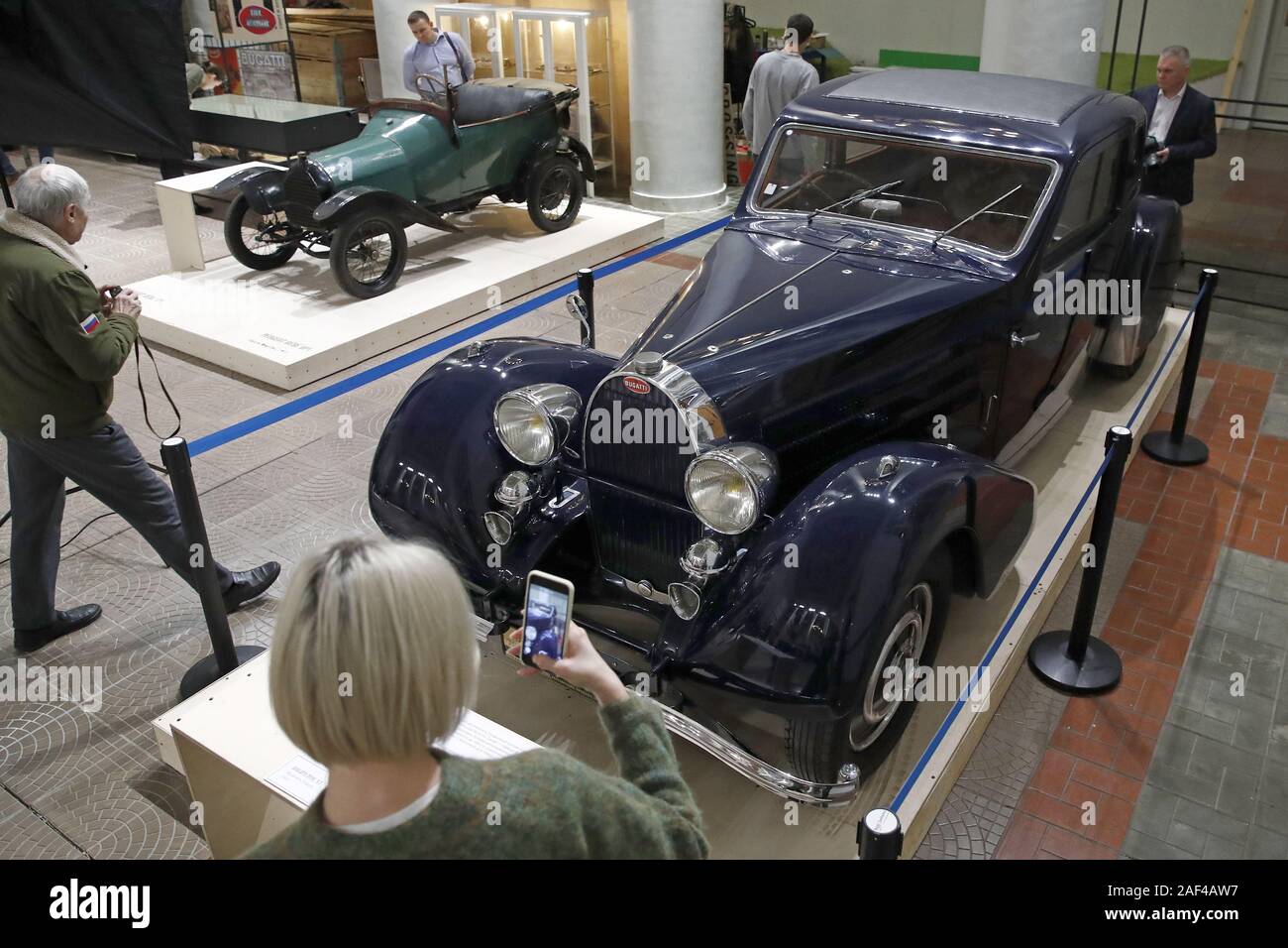 Moscow Russia December 12 19 A Visitor By A Peugeot Bebe Bp1 1913 Car L And A Russo Balt K12 1911 Car R From A Collection Of The Polytechnic Museum On Display