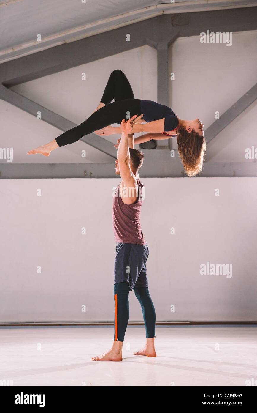 The theme of Acroyoga and Yoga Poses. A pair of two men and a The theme of Acroyoga and Yoga Poses. A pair of two men and a