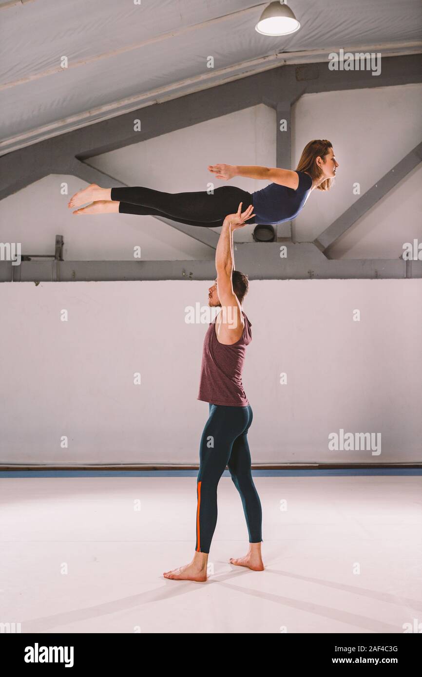 The theme of Acroyoga and Yoga Poses. A pair of two men and a The theme of Acroyoga and Yoga Poses. A pair of two men and a