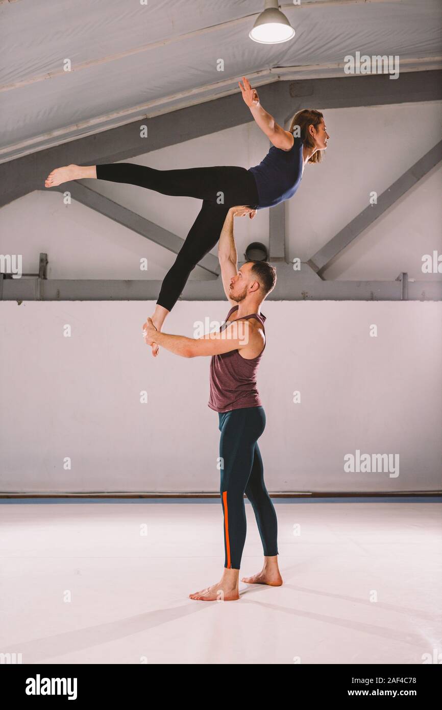 The theme of Acroyoga and Yoga Poses. A pair of two men and a The theme of Acroyoga and Yoga Poses. A pair of two men and a