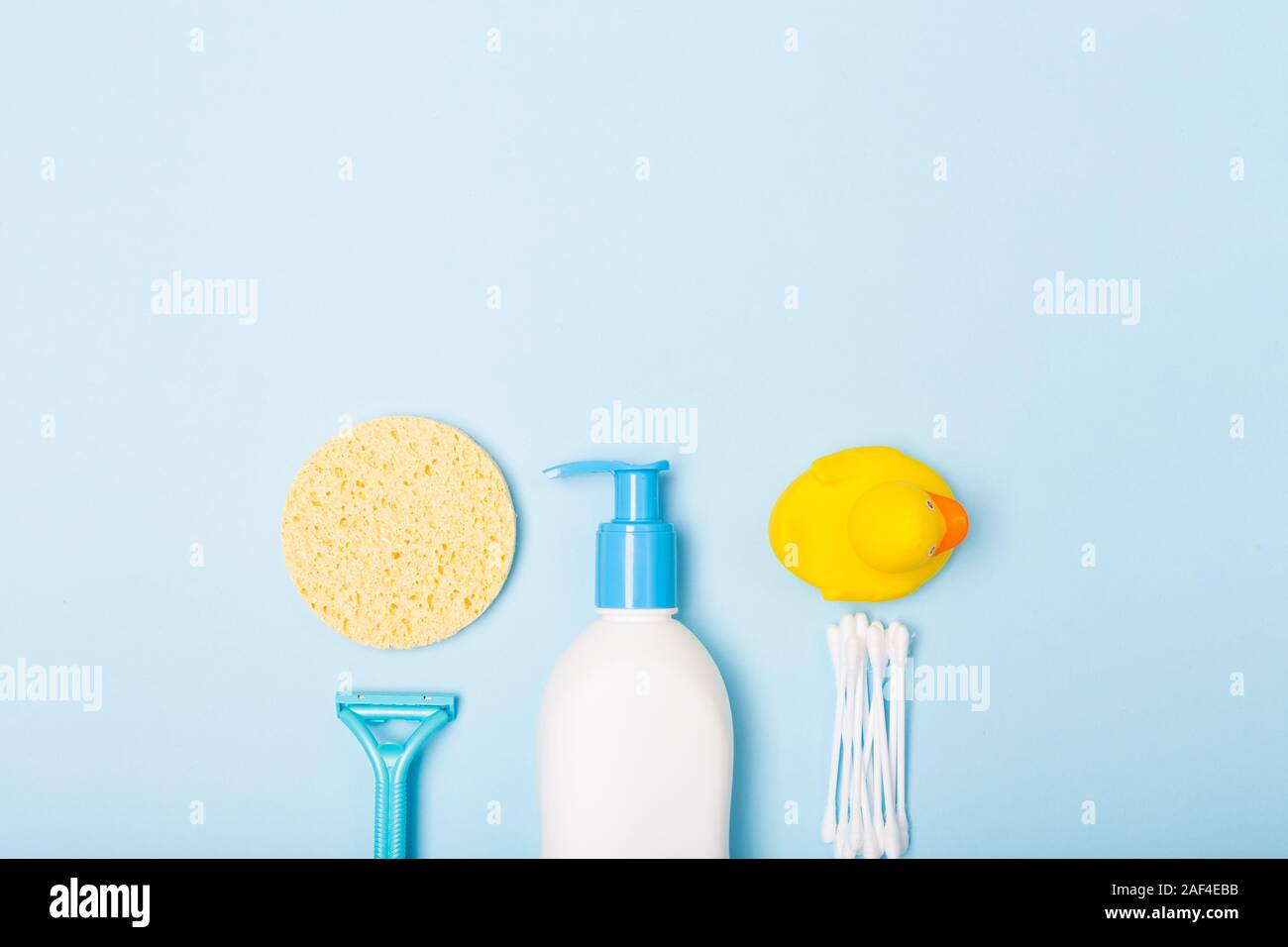 Top view. Woman Bath cleaning care morning routine flat lay composition with white, blue yellow items on light blue desk Stock Photo