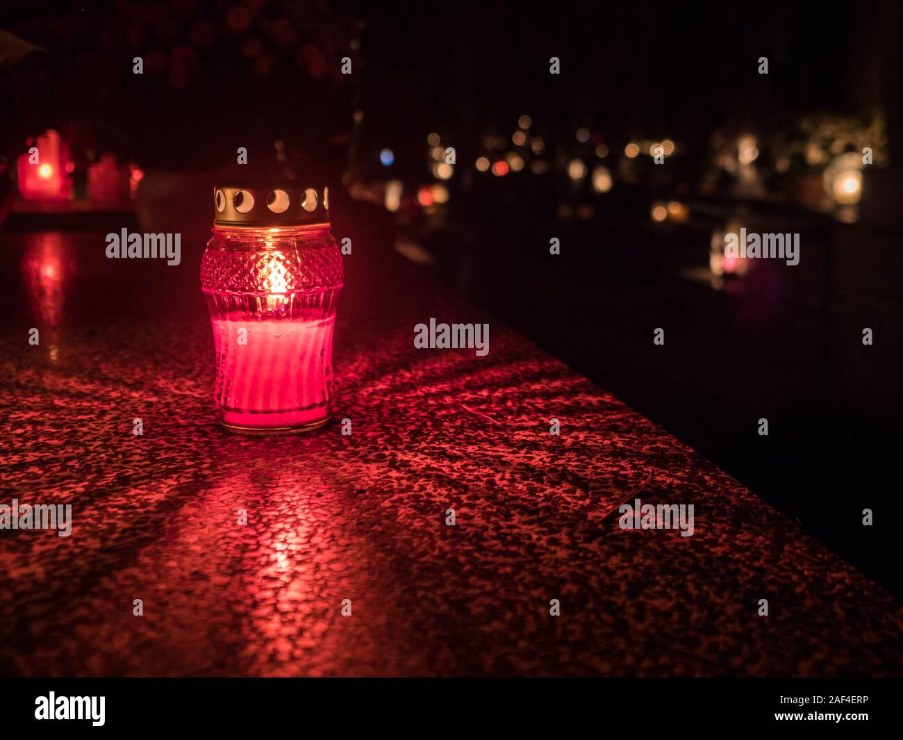 The cemetery torch burns with a bright light in the dark night and