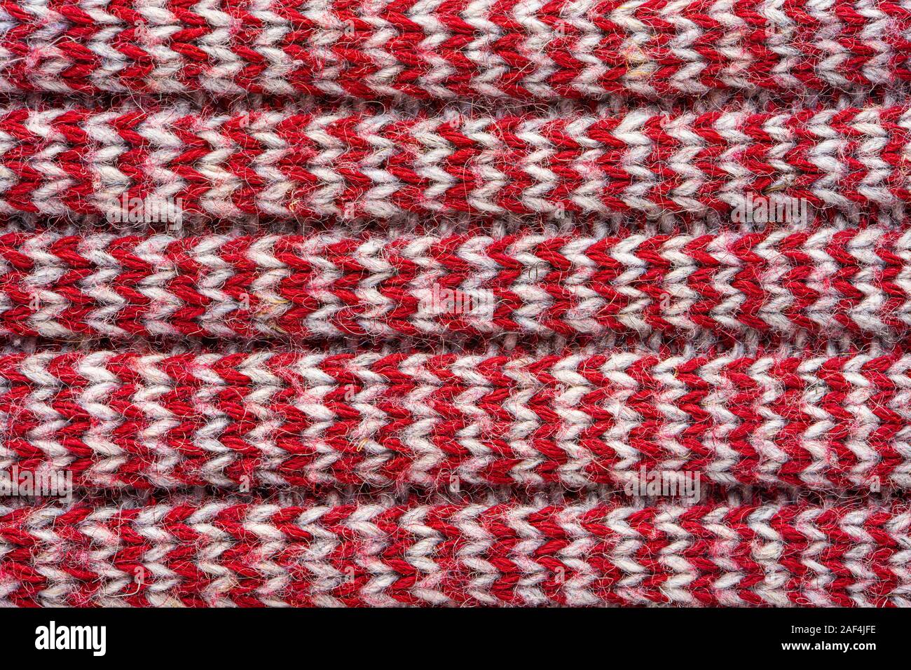 Knitted sweater texture. White and burgundy pattern. Background. Copy space Stock Photo