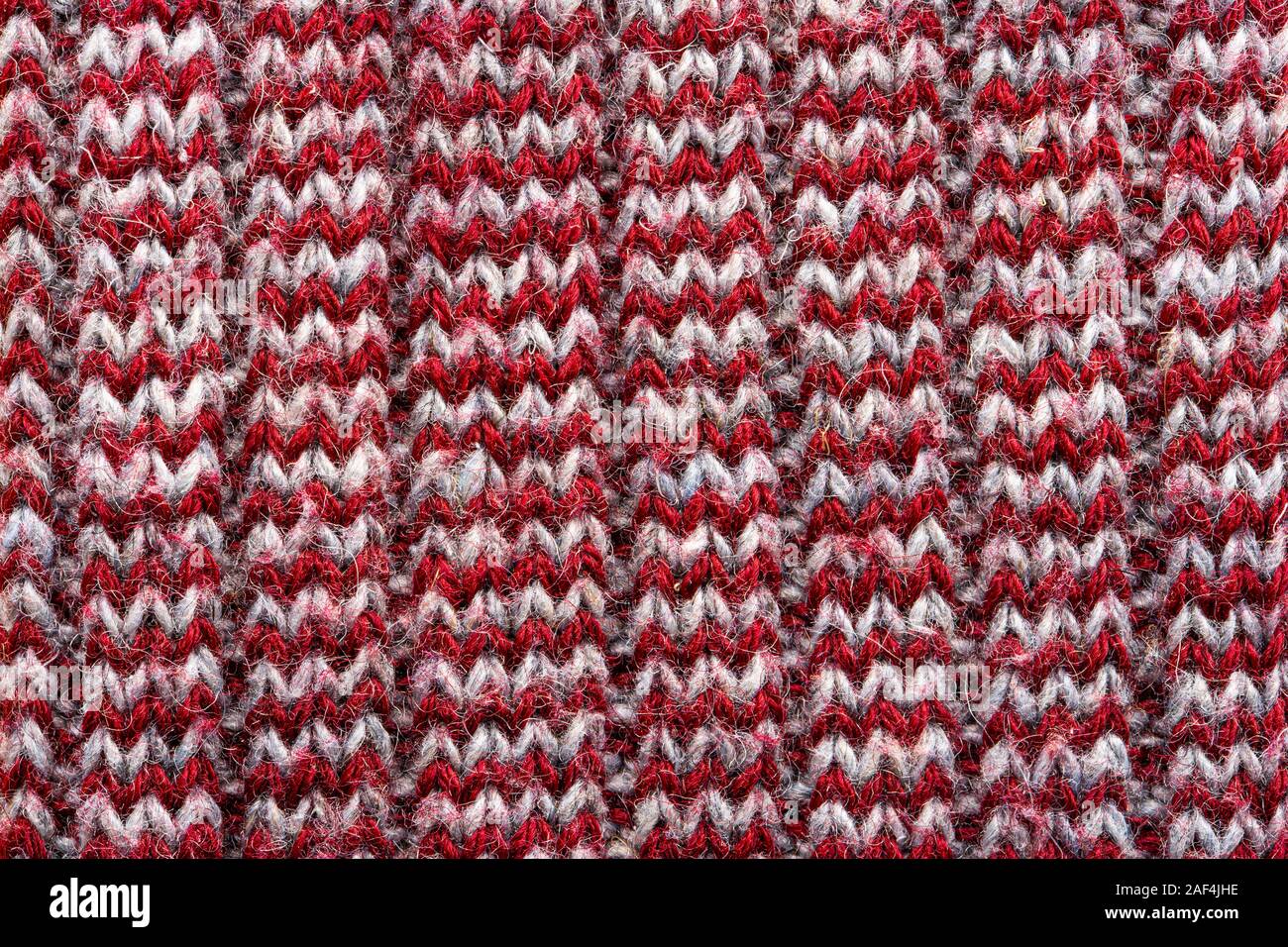 Knitted sweater texture. White and burgundy pattern. Background. Copy space Stock Photo