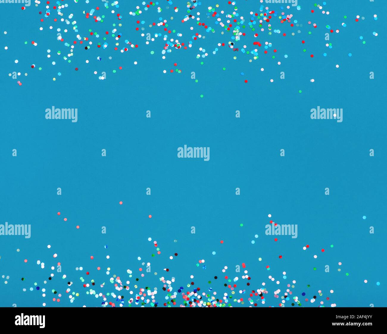 Colorful confetti on blue background with copy space Stock Photo - Alamy