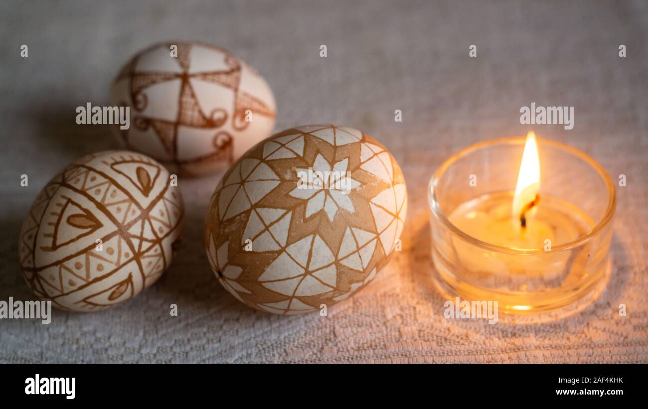 Traditional Ukrainian Easter eggs hot wax painted and a burning candle