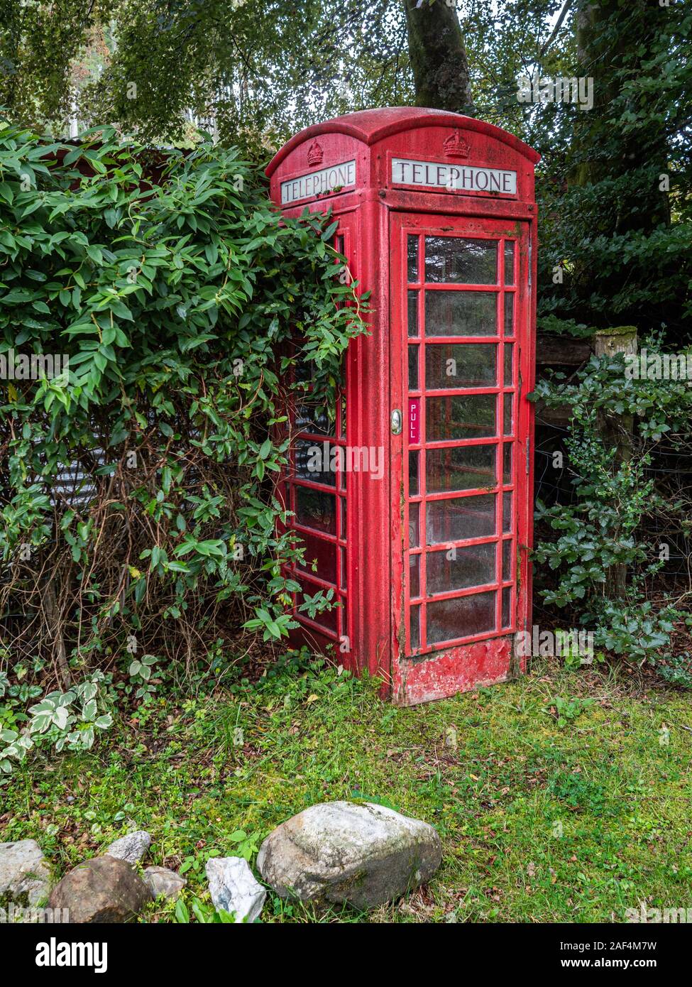 An old K6 type red telephone booth which were introduced by the General Post Office in the UK over many years. Stock Photo