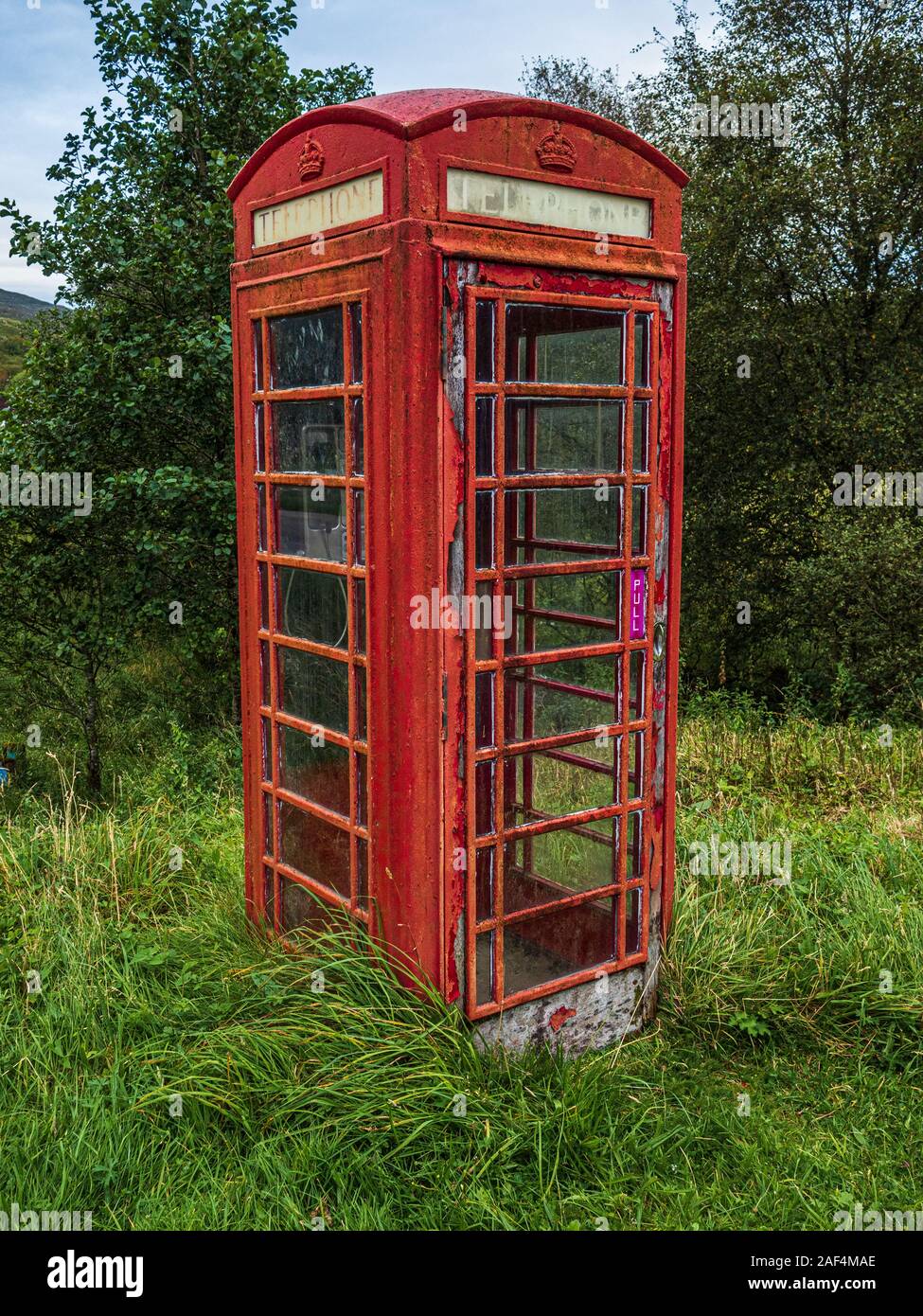 An old K6 type red telephone booth which were introduced by the General Post Office in the UK over many years. Stock Photo