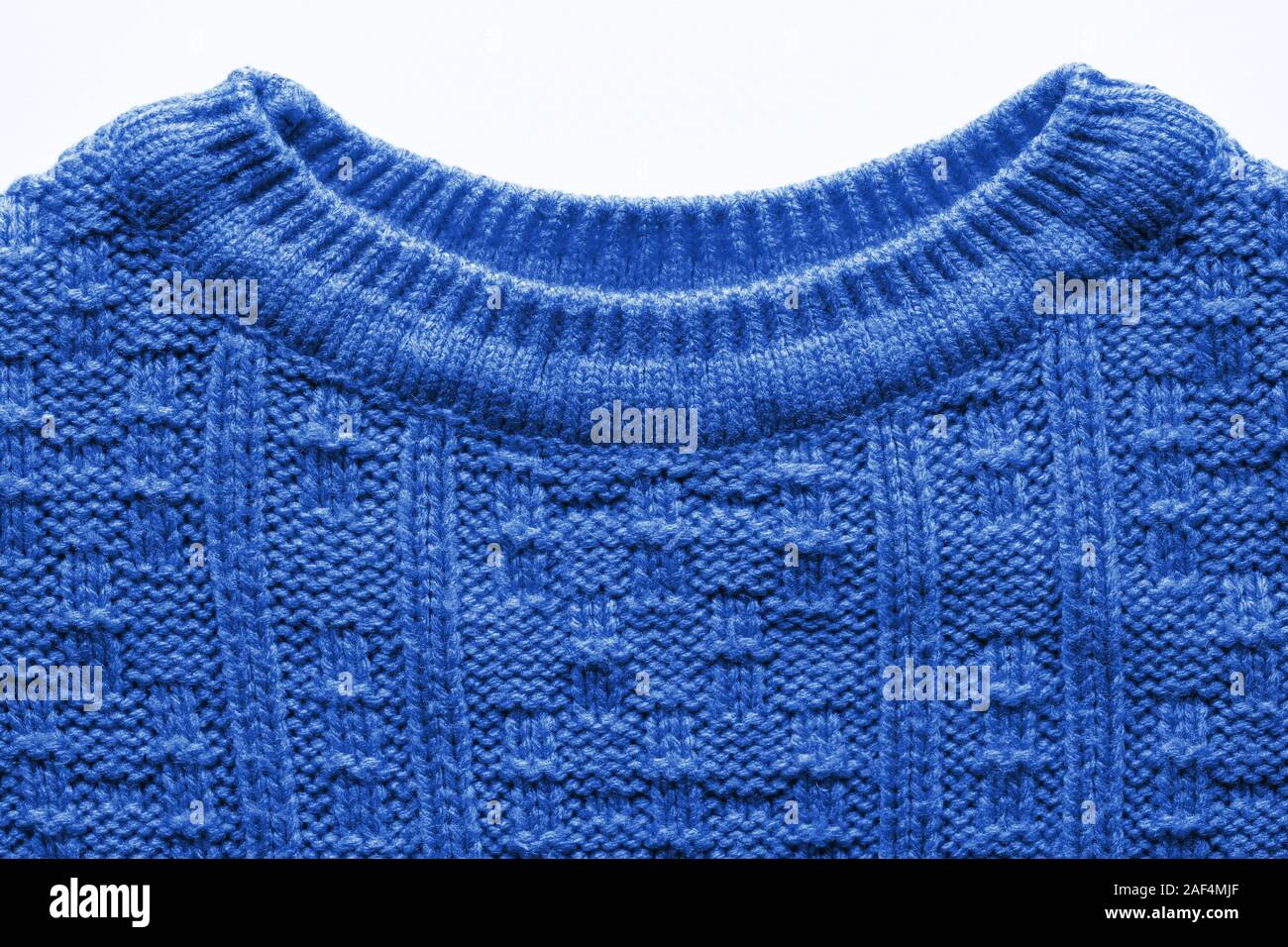 The texture of a knitted sweater. Blue pattern. Facial surface ...