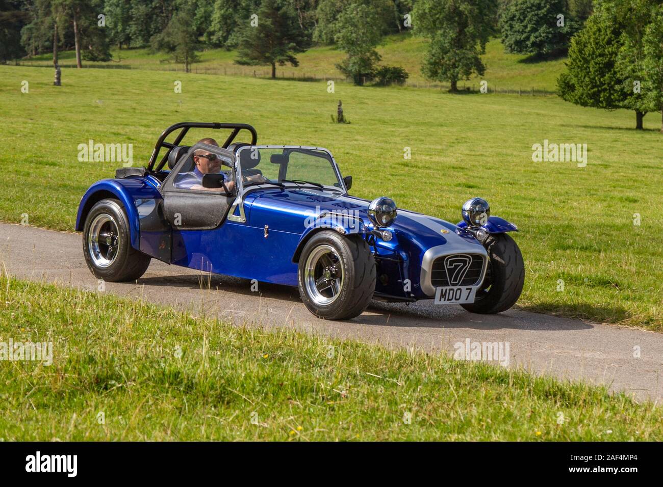 2001 Blue Silver Caterham 7; Classic cars, historics, cherished, old timers, collectable restored vintage veteran, vehicles of yesteryear arriving for the Mark Woodward historical motoring event at Leighton Hall, Carnforth, UK Stock Photo