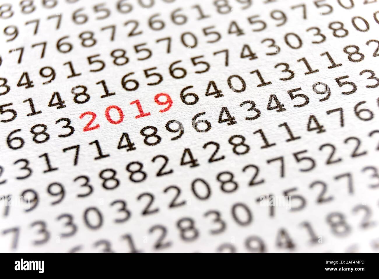 Background with black printed random numbers and the numbers 2019 in red for use as a template for a new year card or annual report. Stock Photo