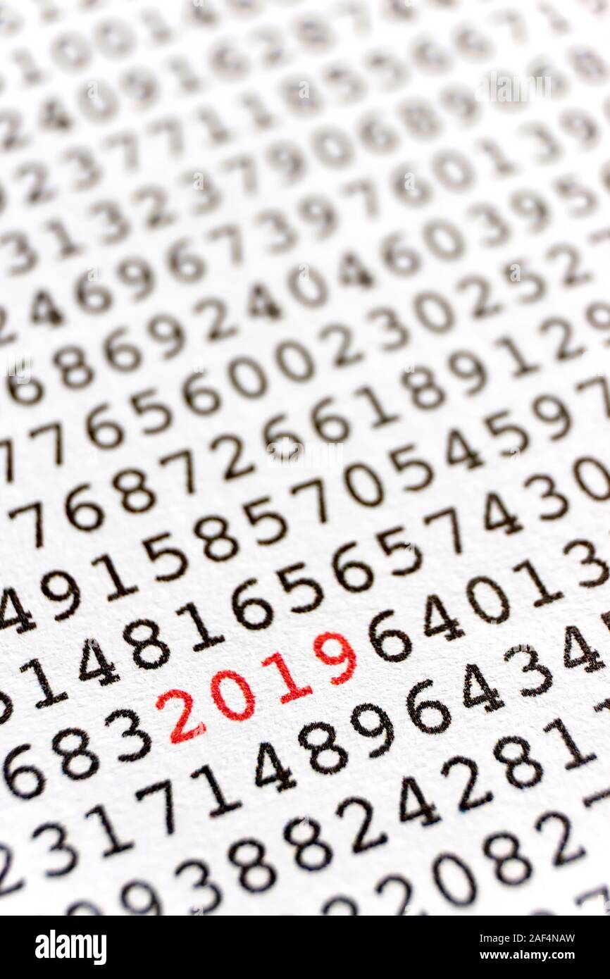 Background with black printed random numbers and the numbers 2019 in red for use as a template for a new year card or annual report. Vertical image. Stock Photo