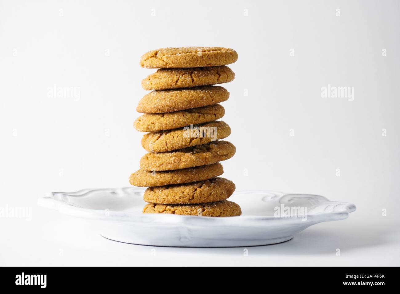 A stack of ginger cookies on a white plate isolated on a white background with copy  space; landscape Stock Photo