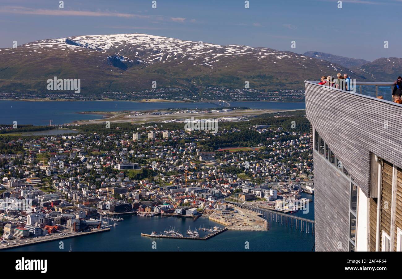 TROMSØ, NORWAY - Tourists enjoy aerial view of city of Tromsø, from Fjellheisen cable car viewing platform. Stock Photo