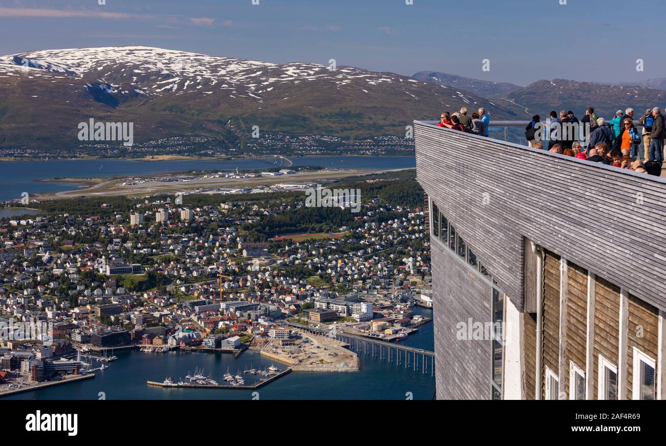TROMSØ, NORWAY - Tourists enjoy aerial view of city of Tromsø, from Fjellheisen cable car viewing platform. Stock Photo