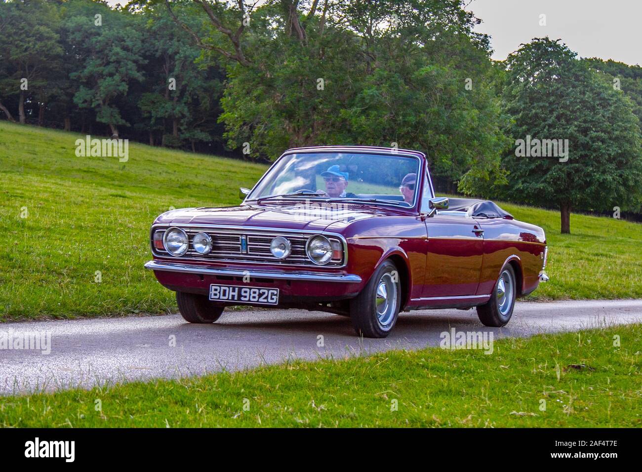 1969 60s maroon Ford Cortina 1600 GT; Classic cars, historics, cherished, old timers, collectable restored vintage veteran, vehicles of yesteryear arriving for the Mark Woodward historical motoring event at Leighton Hall, Carnforth, UK Stock Photo