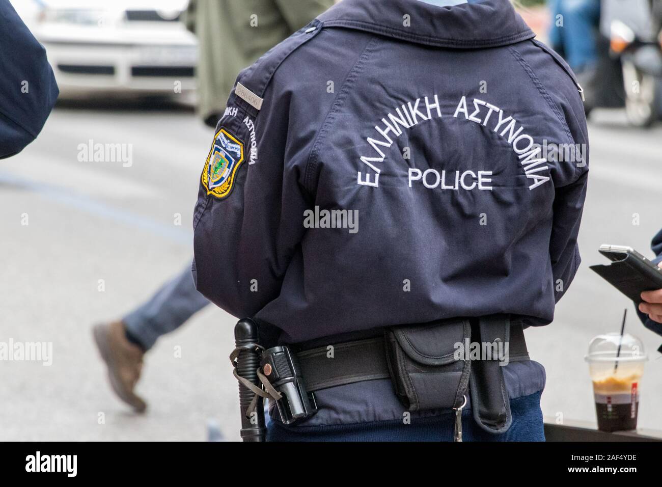 Astynomia police sign-logo on the back of a police uniform standing outdoors. Stock Photo